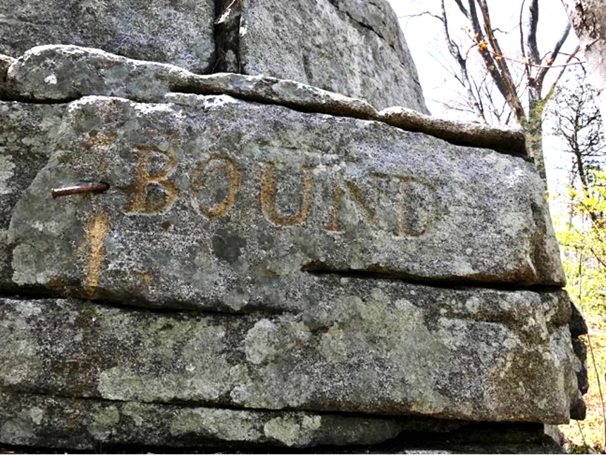 Photo of a rock with BOUND inscribed.